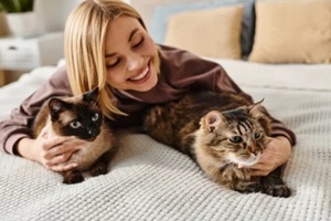 women loving her two pet cats